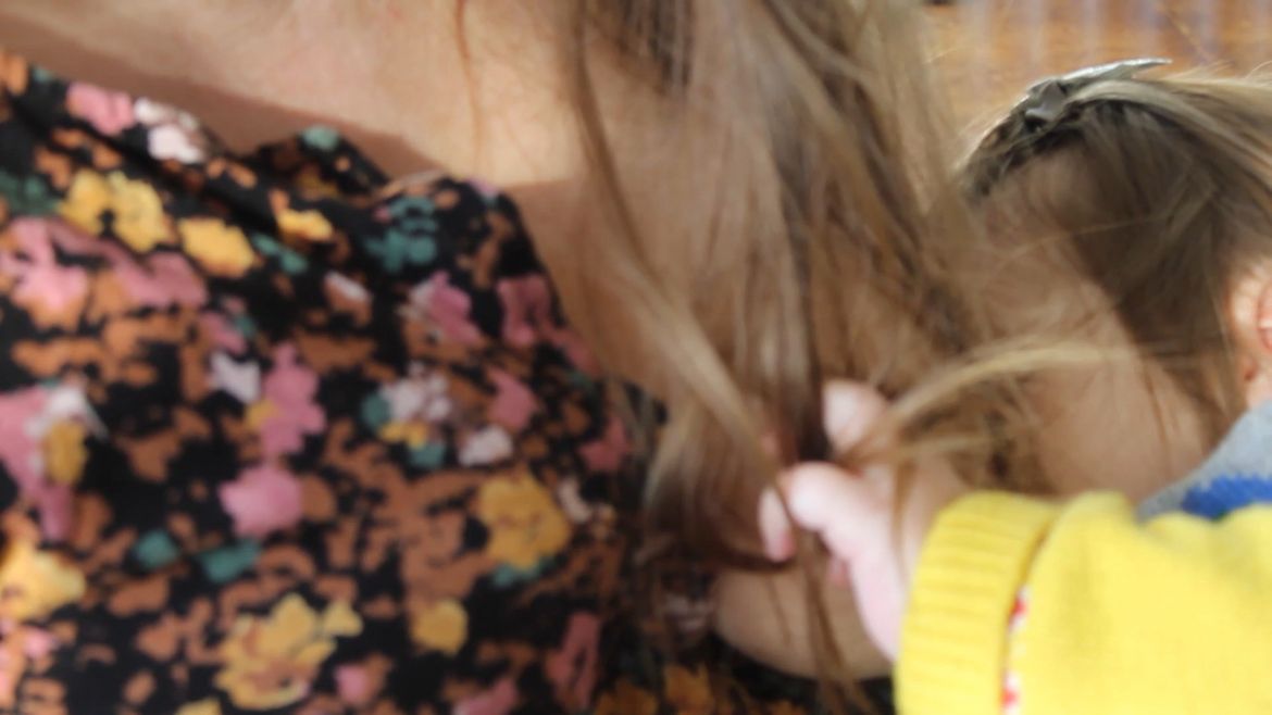 Film still of young girl pulling mother's hair