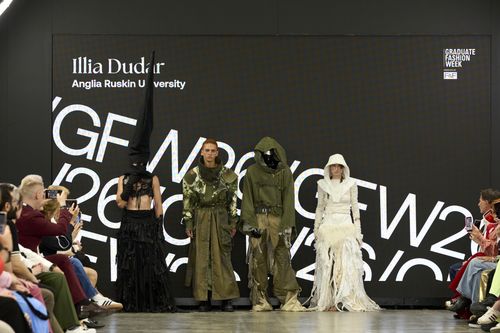 Four models posing for group photo wearing different outfits on GFW 2025 catwalk