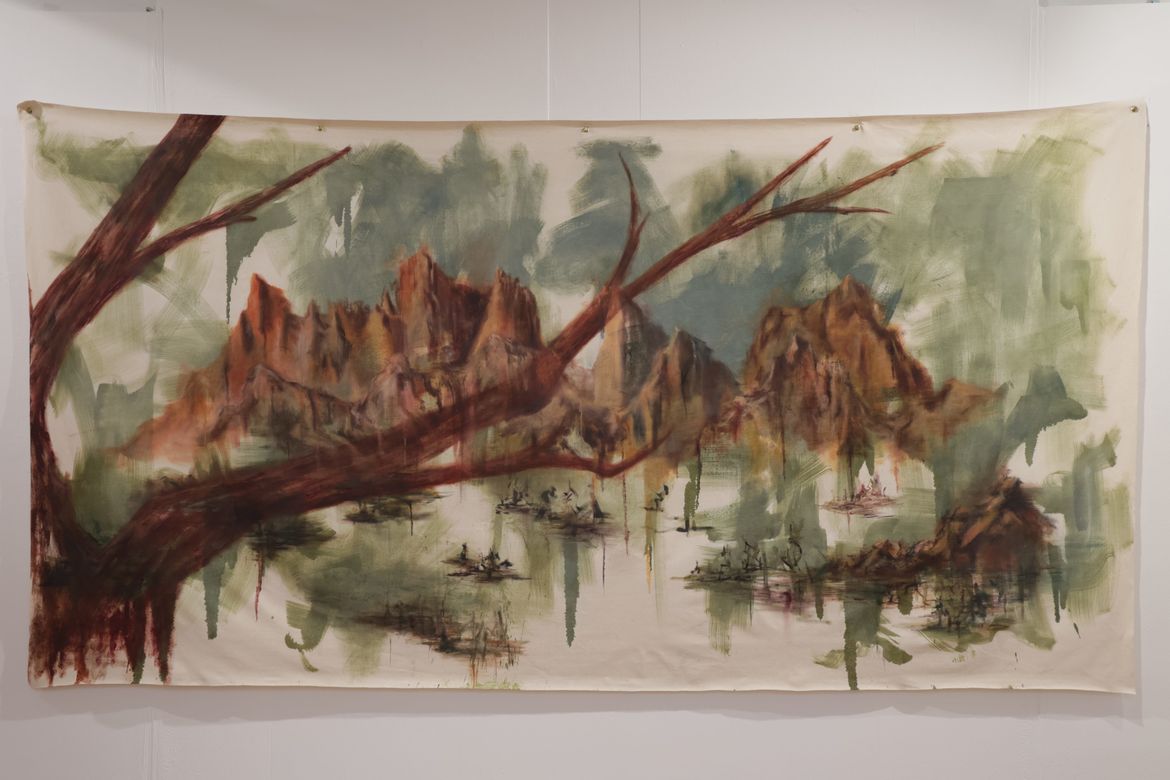 Painting of rocky mountains seen through tree branch