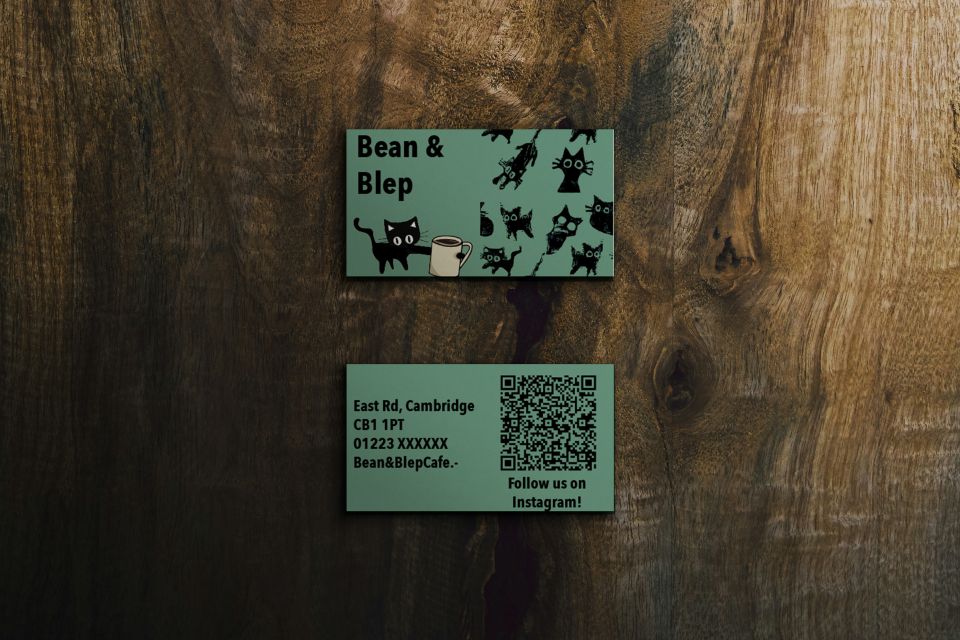 Two business cards for Bean & Blep cafe with black cats on, and business address with QR code