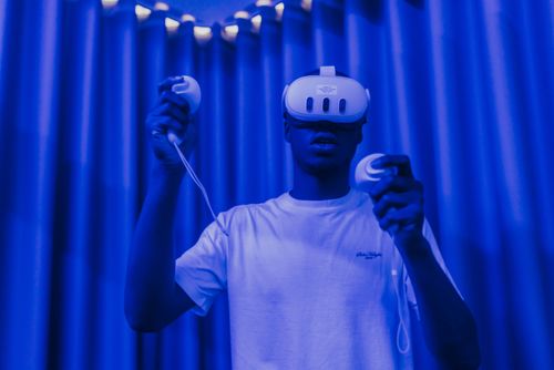A male student using VR equipment in ARU's game development studio, Cambridge