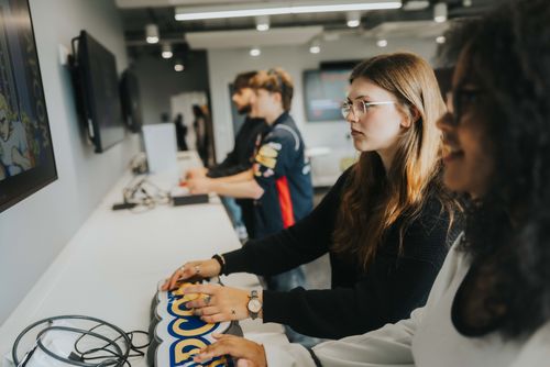 Students playing games in ARU's game development studio, Cambridge