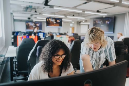 Male and female student working in ARU's games development studio, Cambridge
