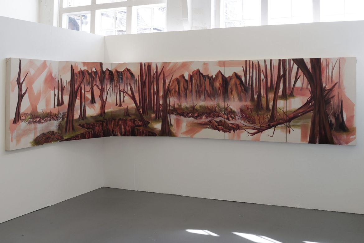 Long landscape image of trees against a plain gallery background