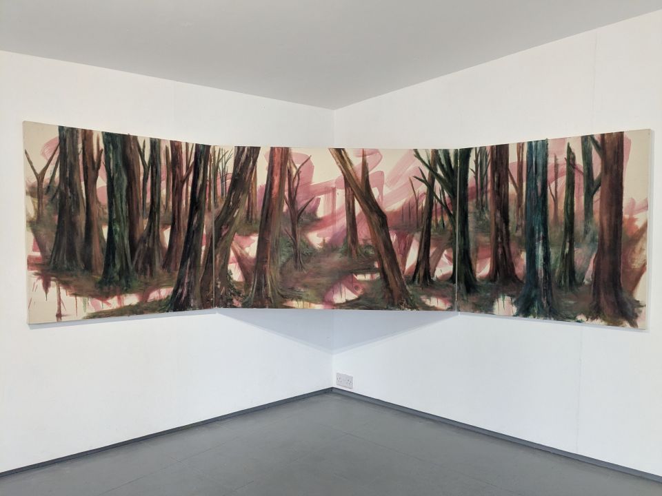 Painting of trees in gallery, suspended across the meeting of two walls