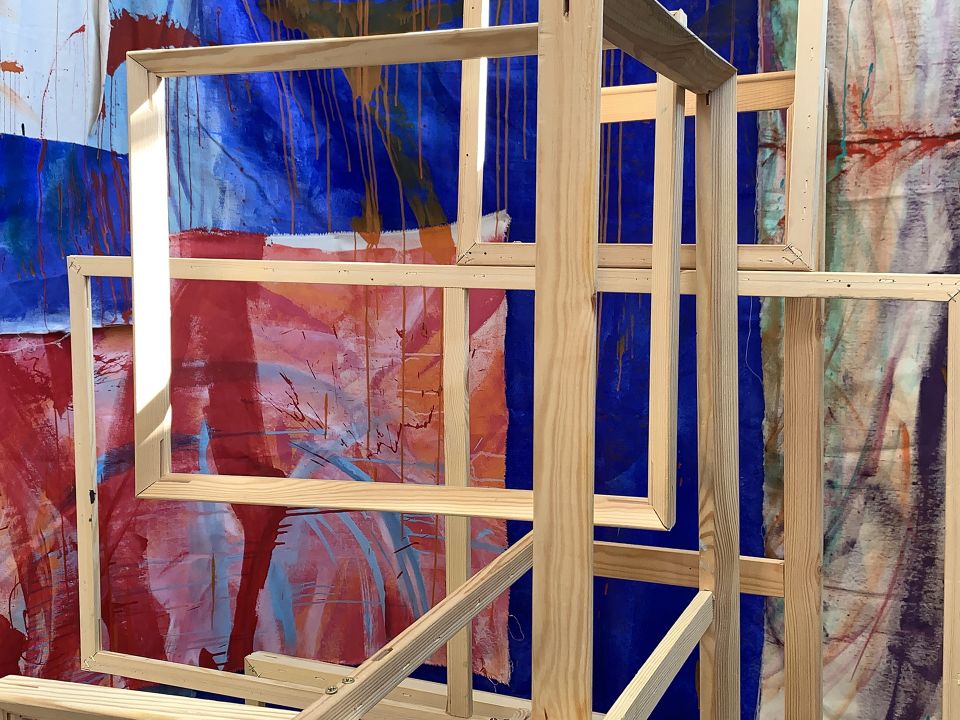 Abstract art piece with canvas, paint, and wood