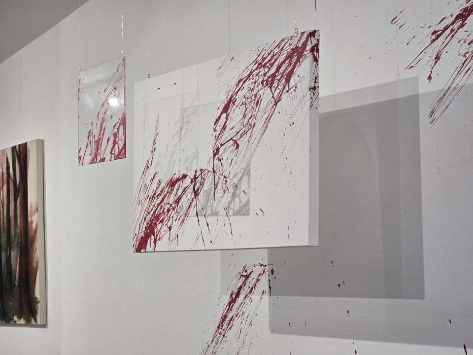 Fine art piece of white canvas splashed with red paint