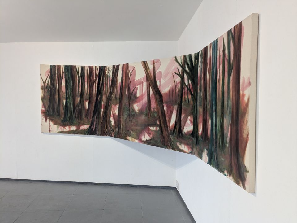 Painting of trees in gallery, suspended across the meeting of two walls