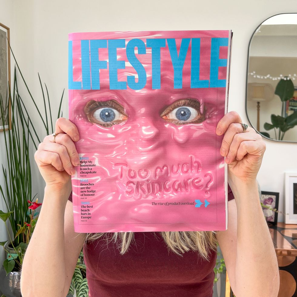 Lisa holding cover of Lifestyle magazine with pair of eyes peeking through pink goo over her face