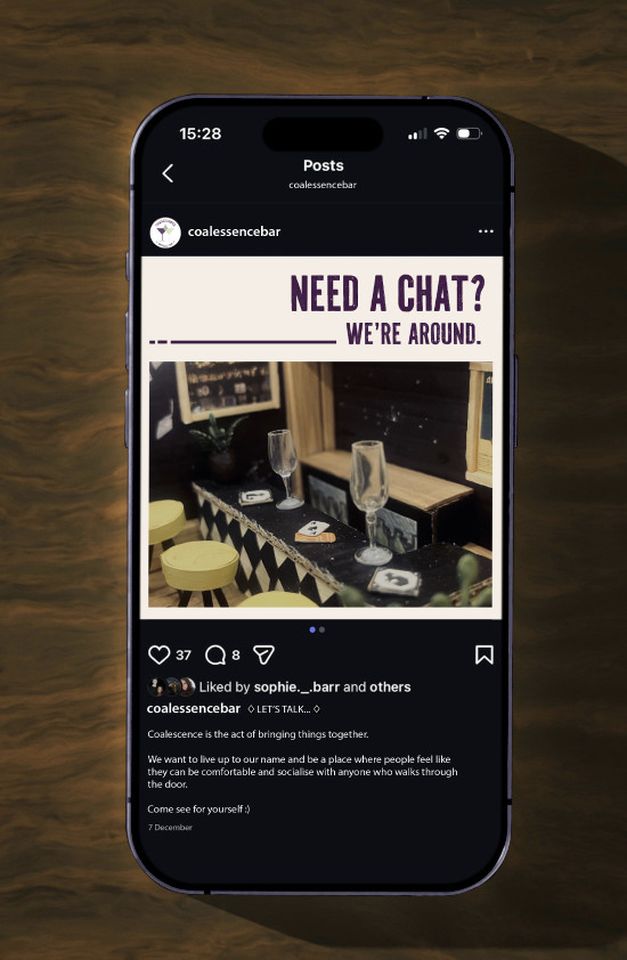 Photo of a phone with a social media post by coalessence bar with words "Need a chat? We're around"