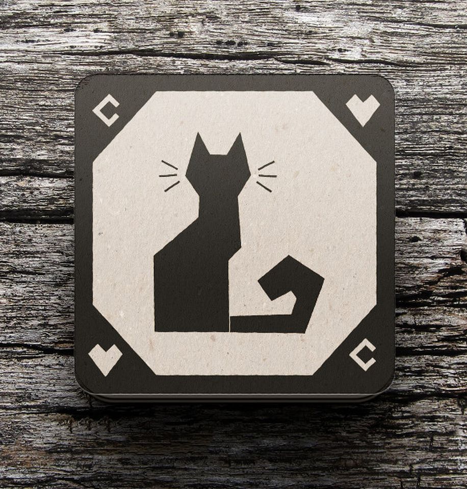 Photo of a coaster with a black cat design on