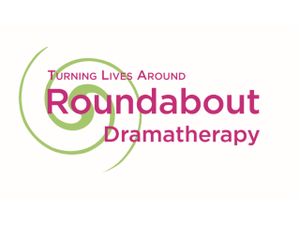 Logo for Roundabout Dramatherapy with a green spiral and the text “Turning Lives Around” in pink and green.