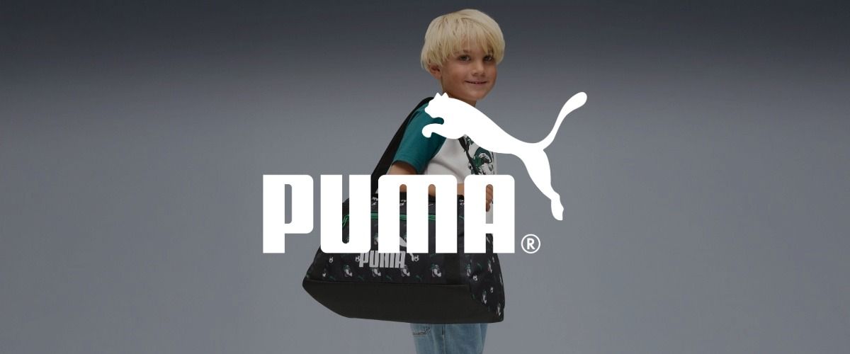 Ein Kind mit blonden Haaren hat lächelnd eine schwarze Puma-Tasche über die Schulter gehängt. Das Logo der Marke PUMA überlagert das Bild.