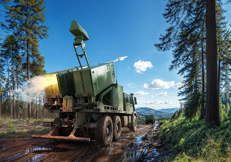 The vehicle is parked in the countryside and is launching a rocket.