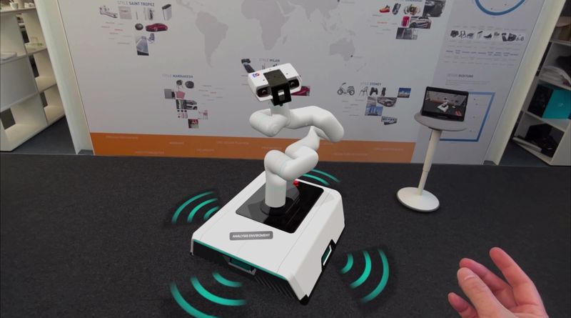 VR Model von eines Roboters welcher von einer Hand gesteuert wird.
