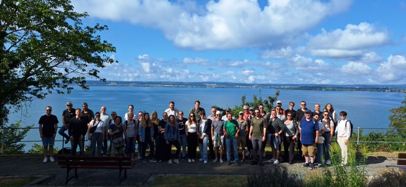 Group photo of all employees in front of Lake Constance.