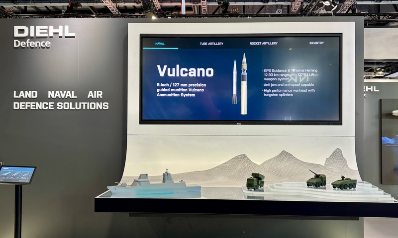 A Diehl exhibition stand with a large screen displaying product information and four vehicle models on a cyclorama.