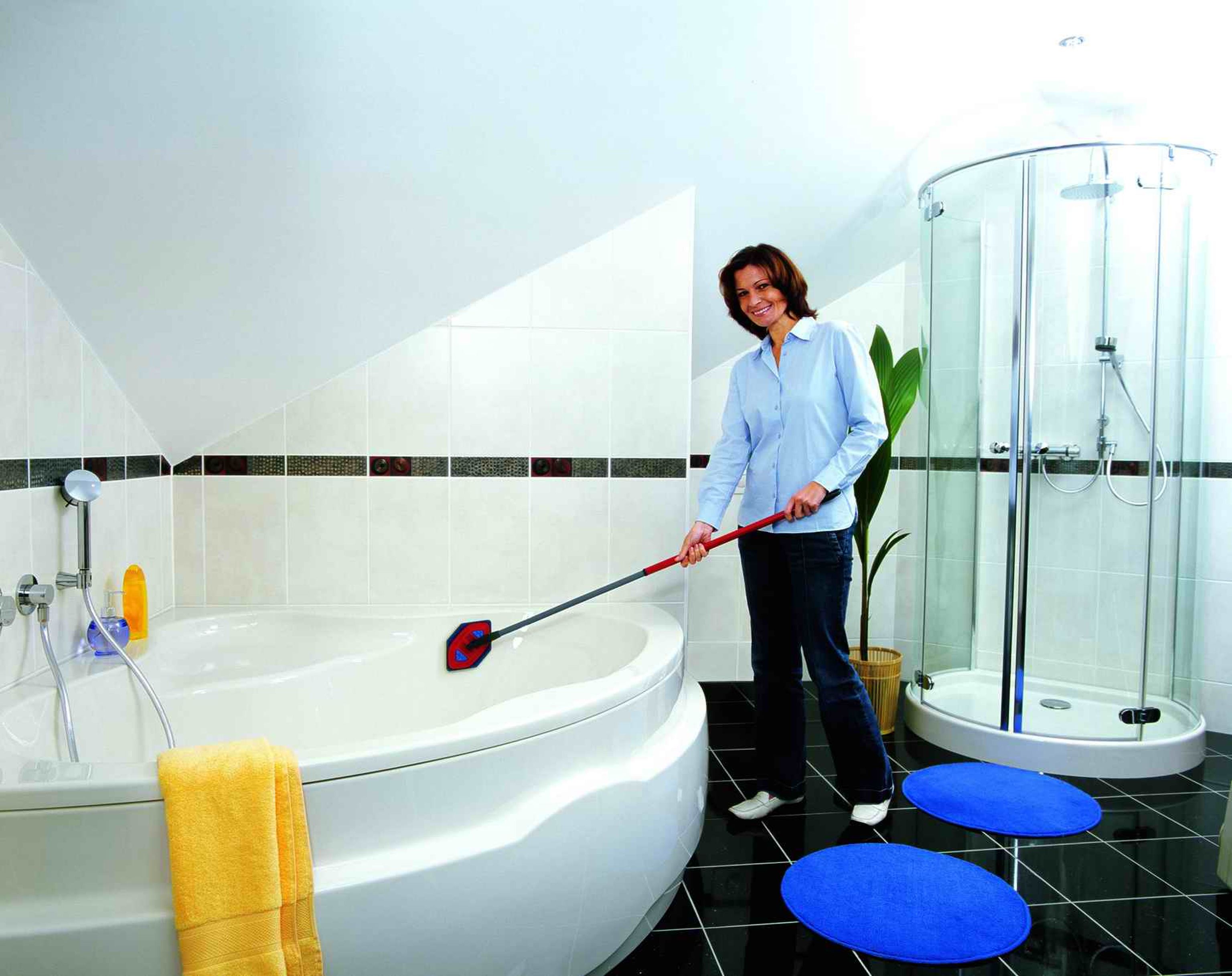 Woman is cleaning a bathroom