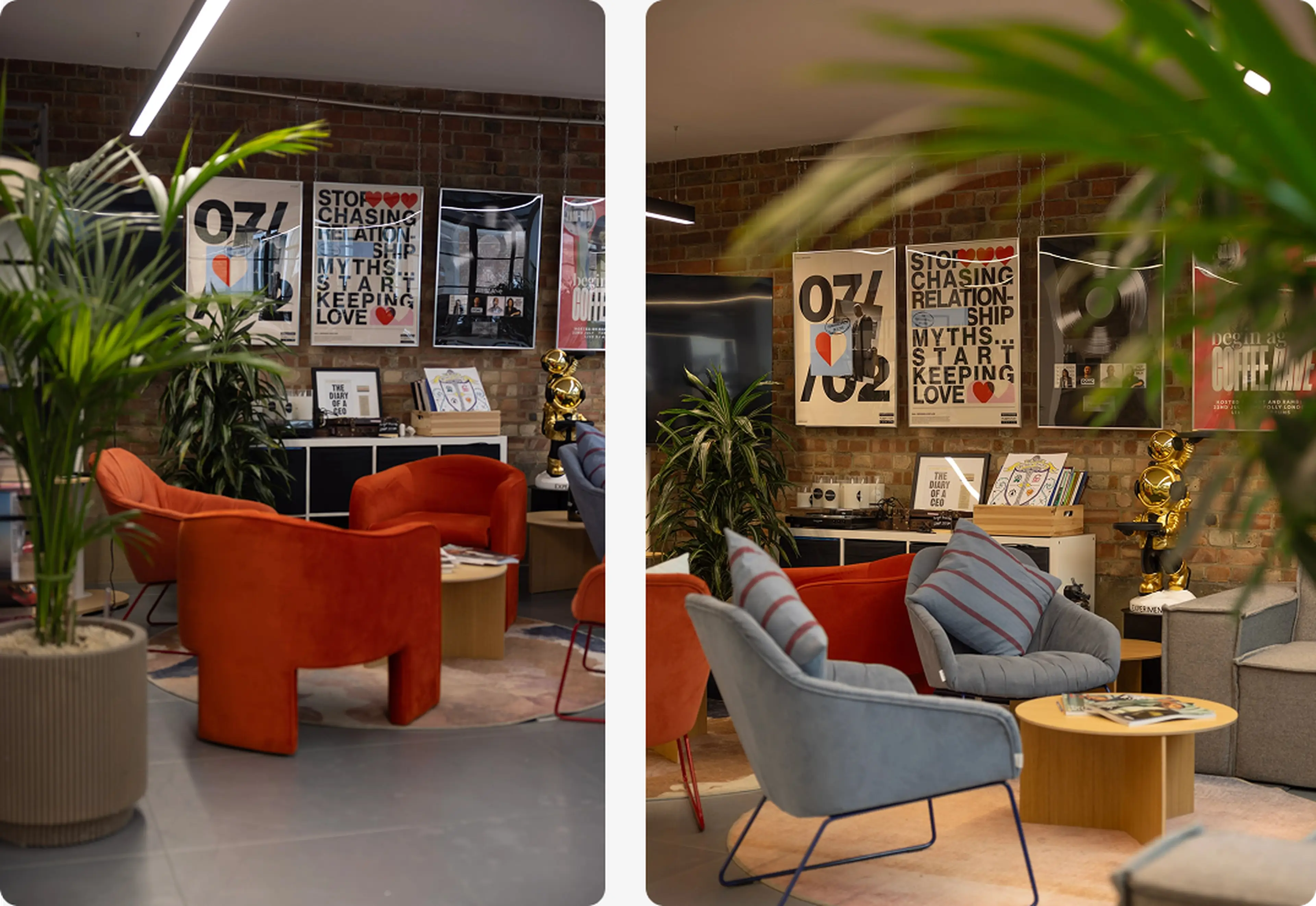 Modern lounge with orange and blue chairs, a wooden table, potted plants, and motivational posters on a brick wall backdrop.