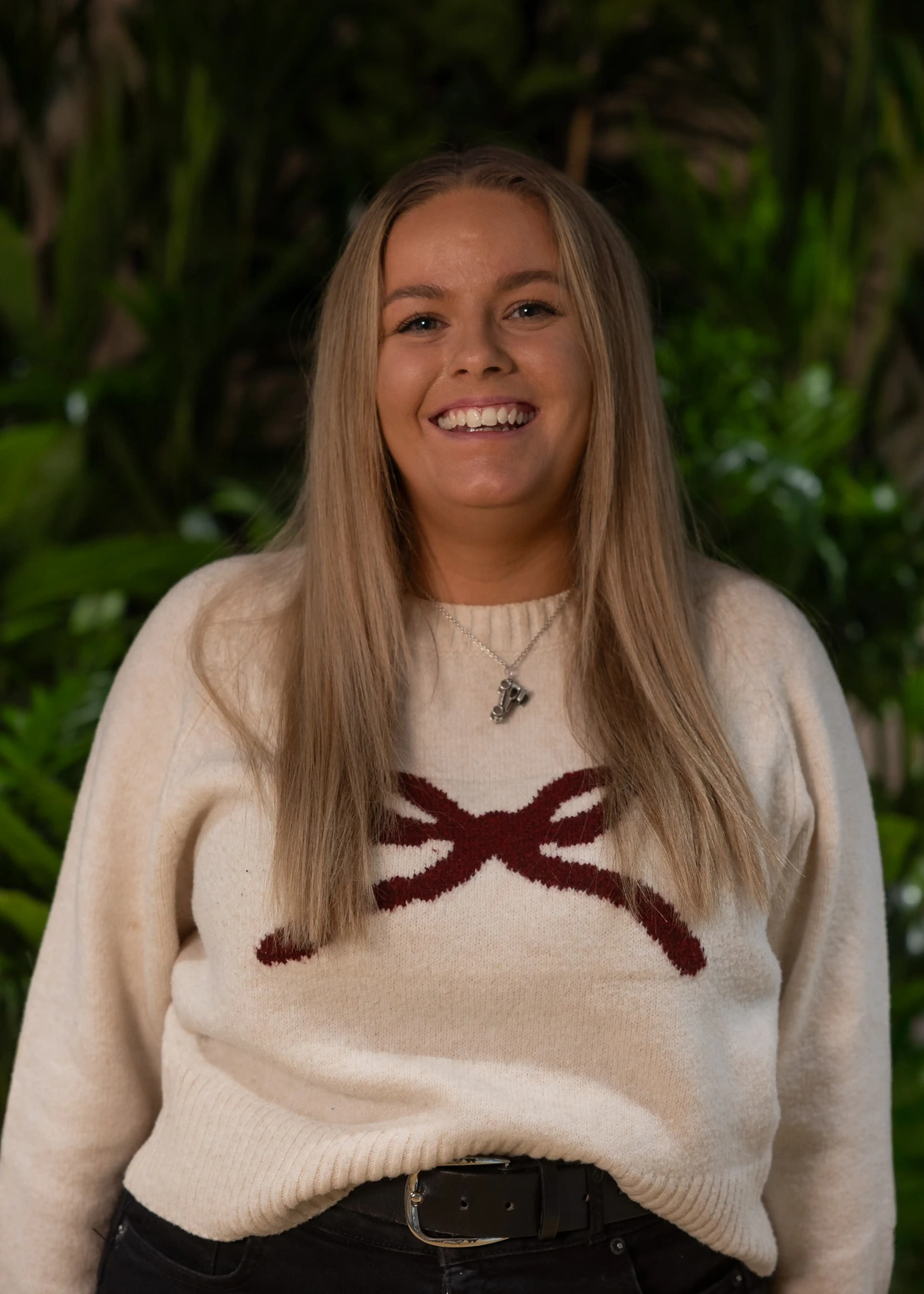 Smiliing lady with blonde hair and white jumper.