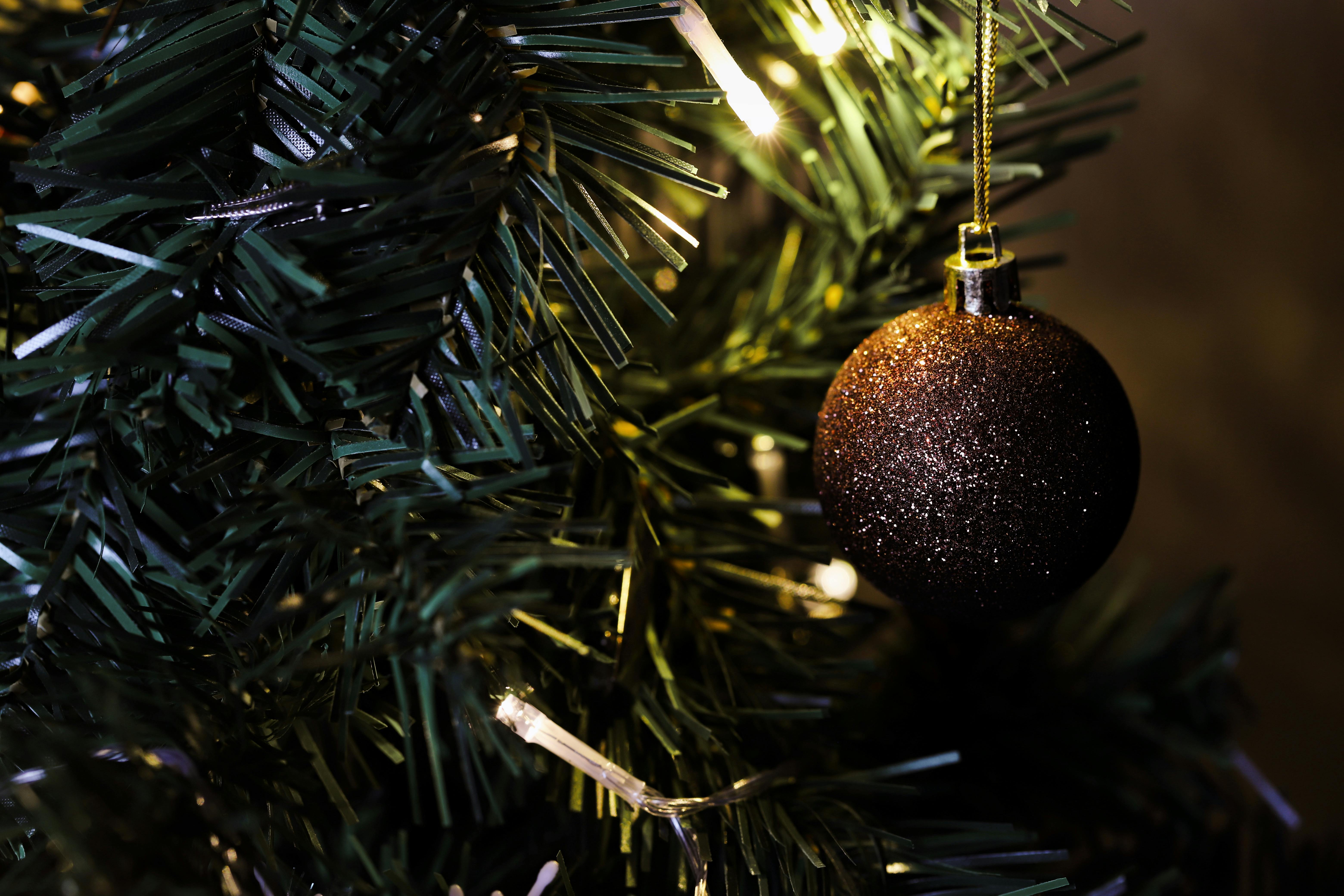 Golden bauble on replica christmas tree