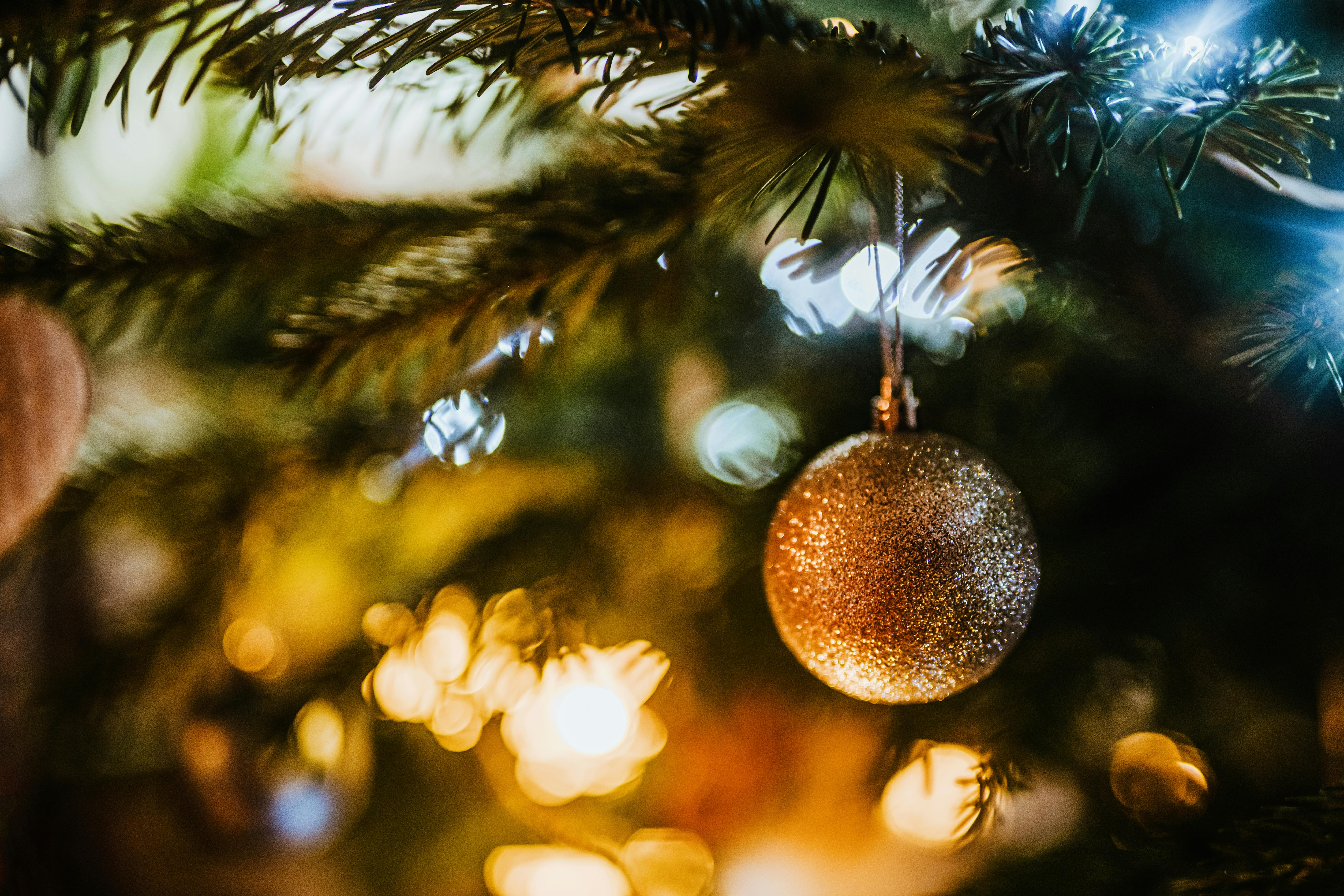 A golden bauble on a christmas tree