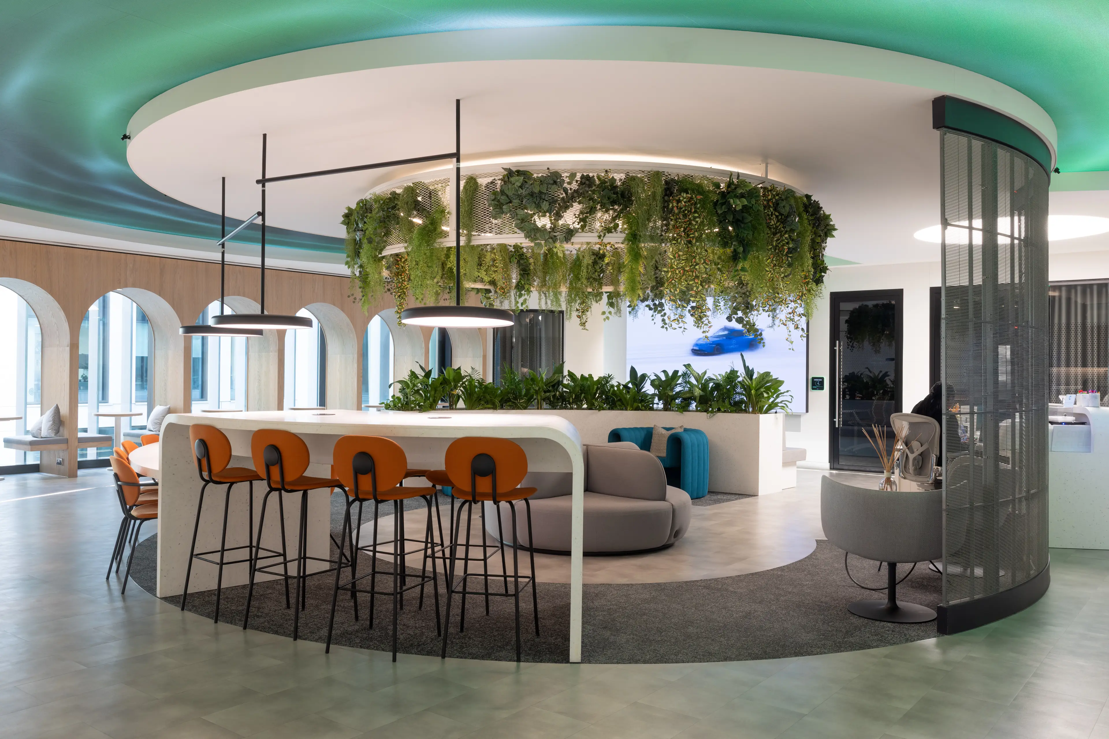 A circular office breakout space with hanging plants