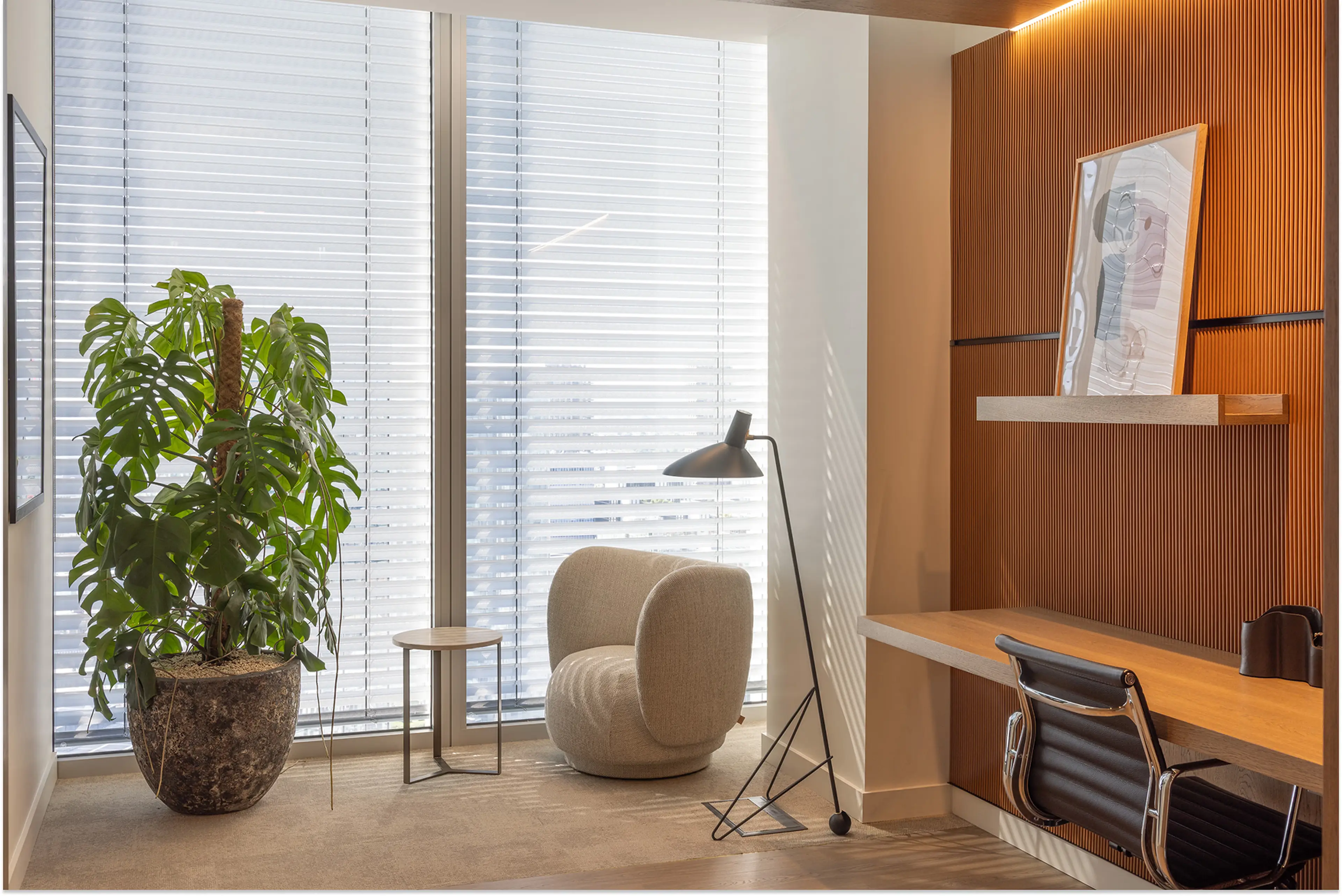 A sleek, modern office with a standing plant in one corner