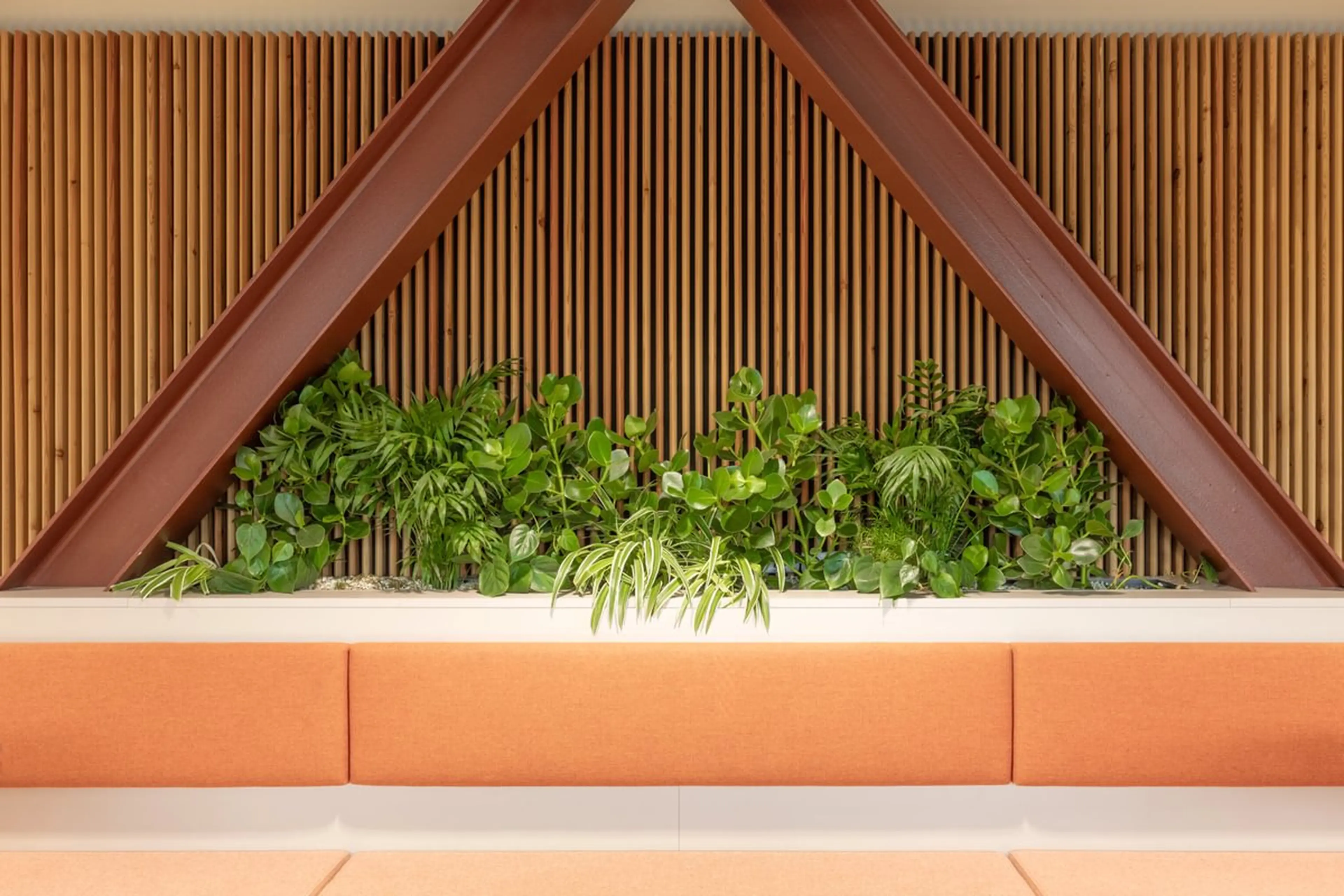 Crossed I beams with planting below, and seeting at the foot