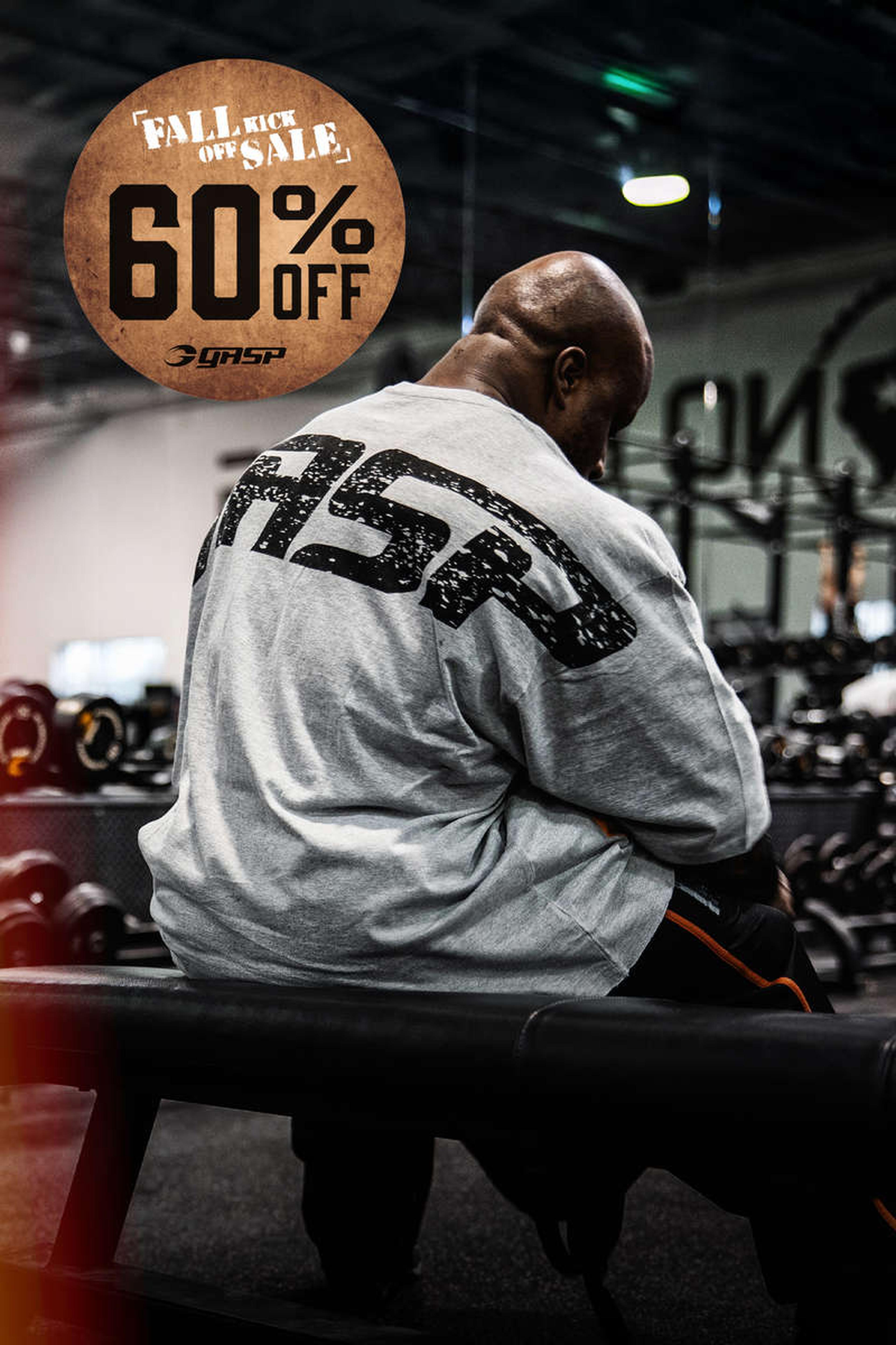 Man in a gym wearing a "GASP" shirt, sitting on a bench. "Fall Kick Off Sale 60% Off" sign above.
