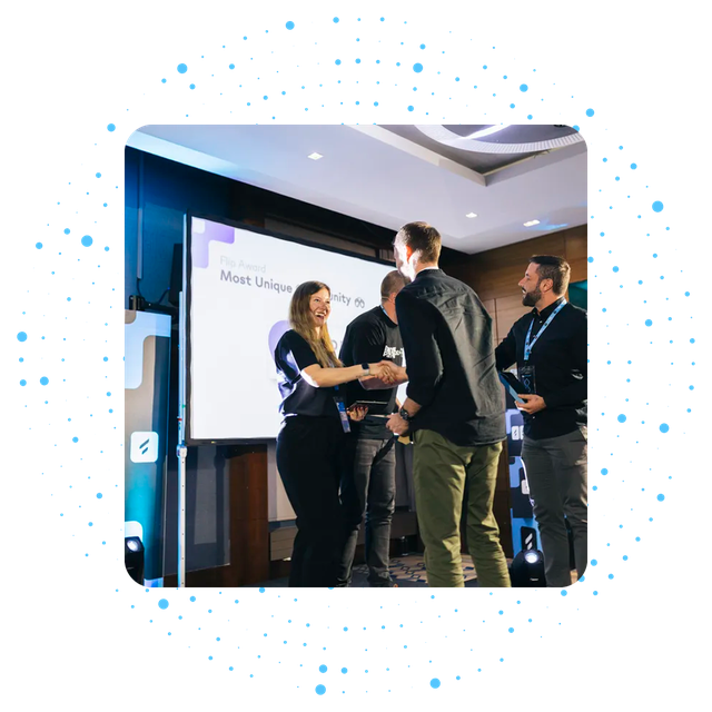 People shaking hands at an award ceremony with Flip Award on screen.