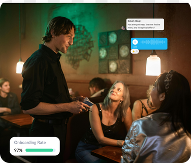 Waiter interacting with customers in a restaurant, text overlay: Onboarding Rate 97%.