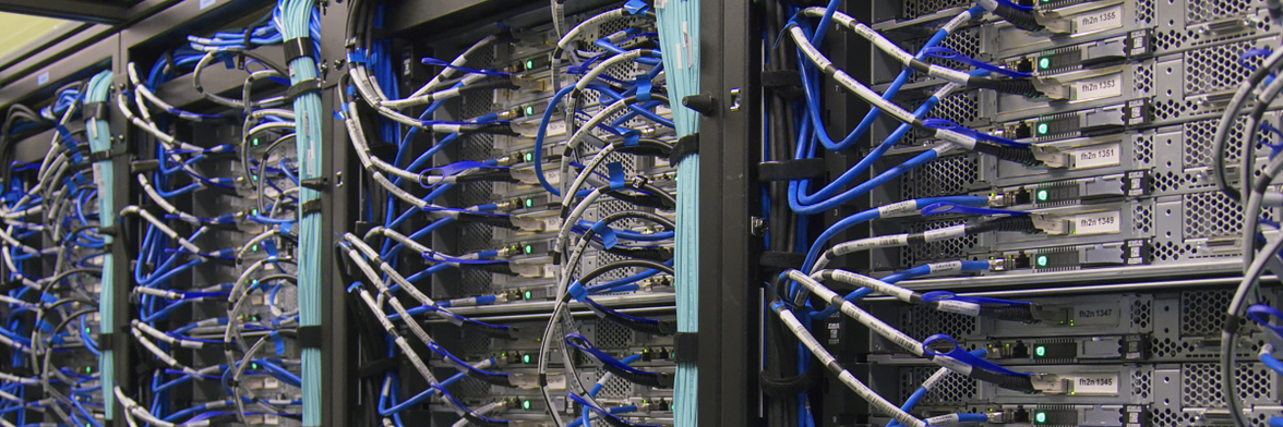 Server racks with blue network cables, illustrating digital infrastructure for HR-Software, Intranet.