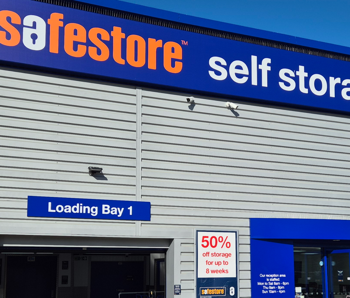 Self-storage facility exterior with "Safestore" branding, a "Loading Bay 1" sign, and a 50% off promotion for up to 8 weeks.