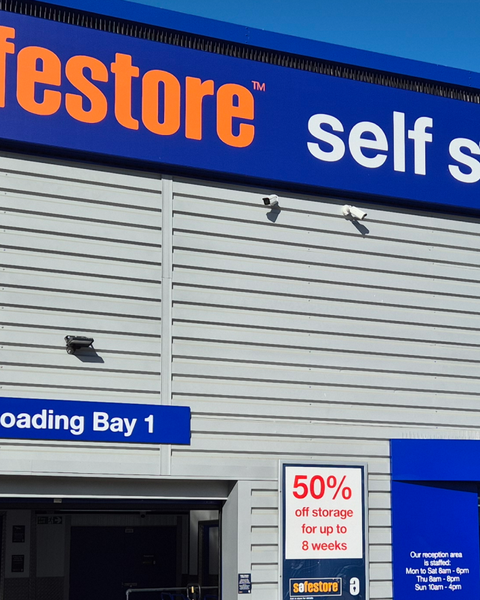 Self-storage facility exterior with "Safestore" branding, a "Loading Bay 1" sign, and a 50% off promotion for up to 8 weeks.