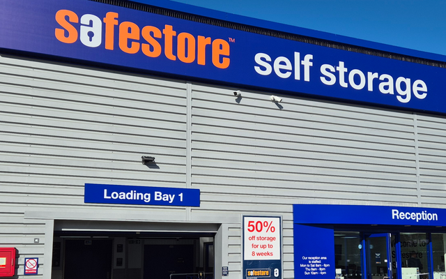 Self-storage facility exterior with "Safestore" branding, a "Loading Bay 1" sign, and a 50% off promotion for up to 8 weeks.