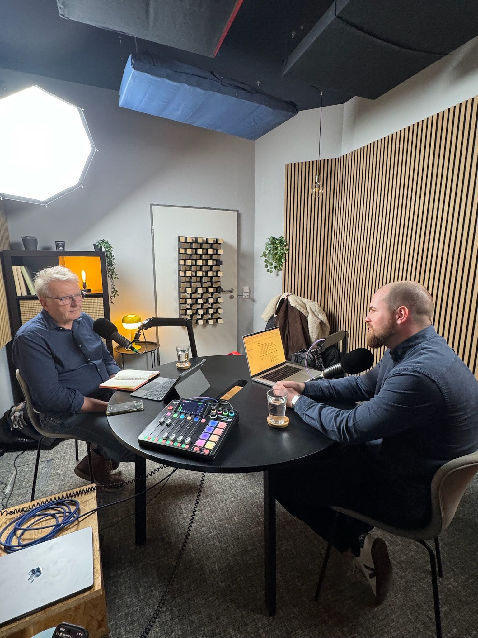 Two people having a podcast discussion in a studio.