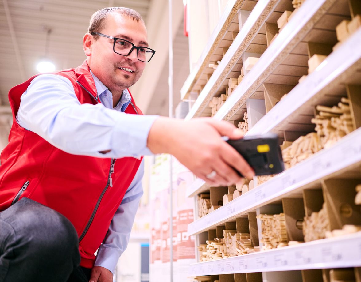 Employee scanning products in a hardware store.
