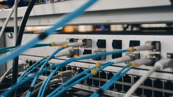 Network cables connected to a server for IT security and device connectivity in a data center.