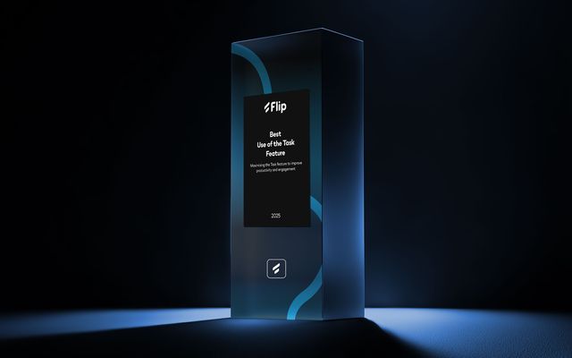 Glass award with Flip Best Use of the Task Feature 2025 text, spotlighted on dark background.