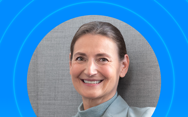 Smiling person in a professional setting with blue circular overlay.