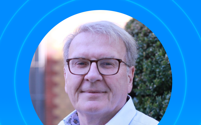 Portrait of a man with glasses and a blue shirt