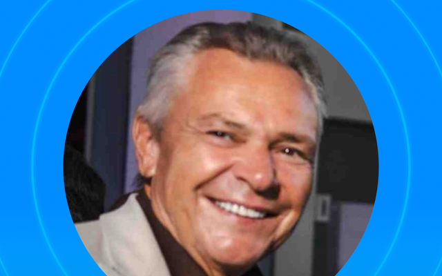 Portrait of a smiling person with a blue circular background.