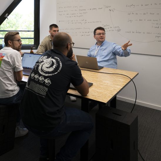 People in a meeting discussing business strategy at a conference table.