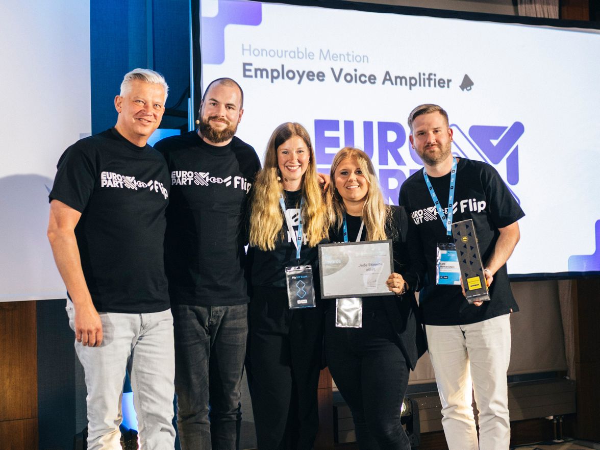 Five people in EURO PART x Flip shirts hold an award; screen reads Honourable Mention Employee Voice Amplifier.