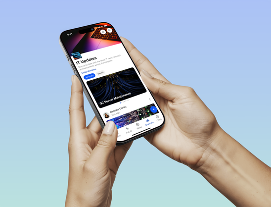 Person holding phone displaying IT Updates on an intranet app.