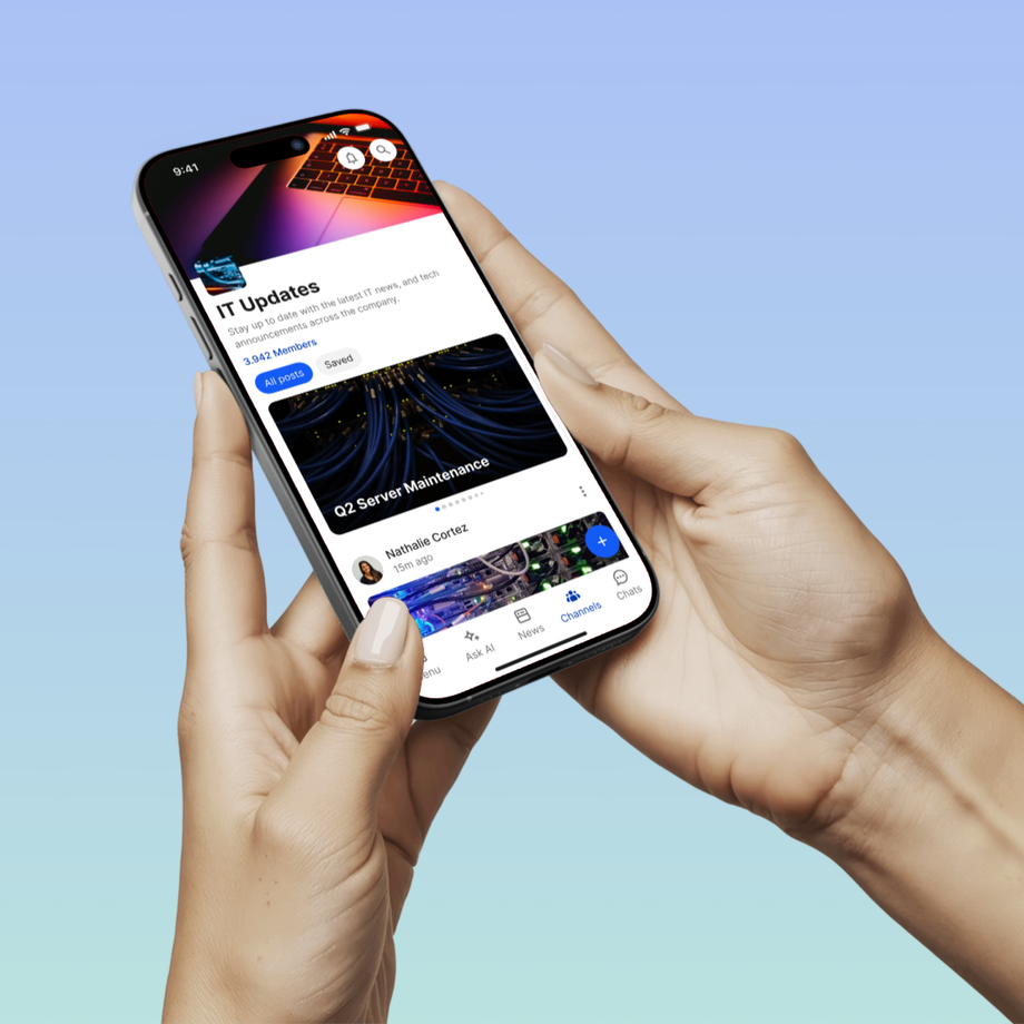 Person holding phone displaying IT Updates on an intranet app.