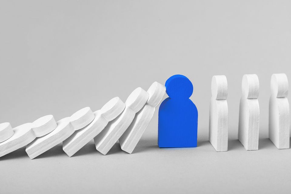 Blue figure stops falling white figures, symbolizing employee communication in crisis situations.