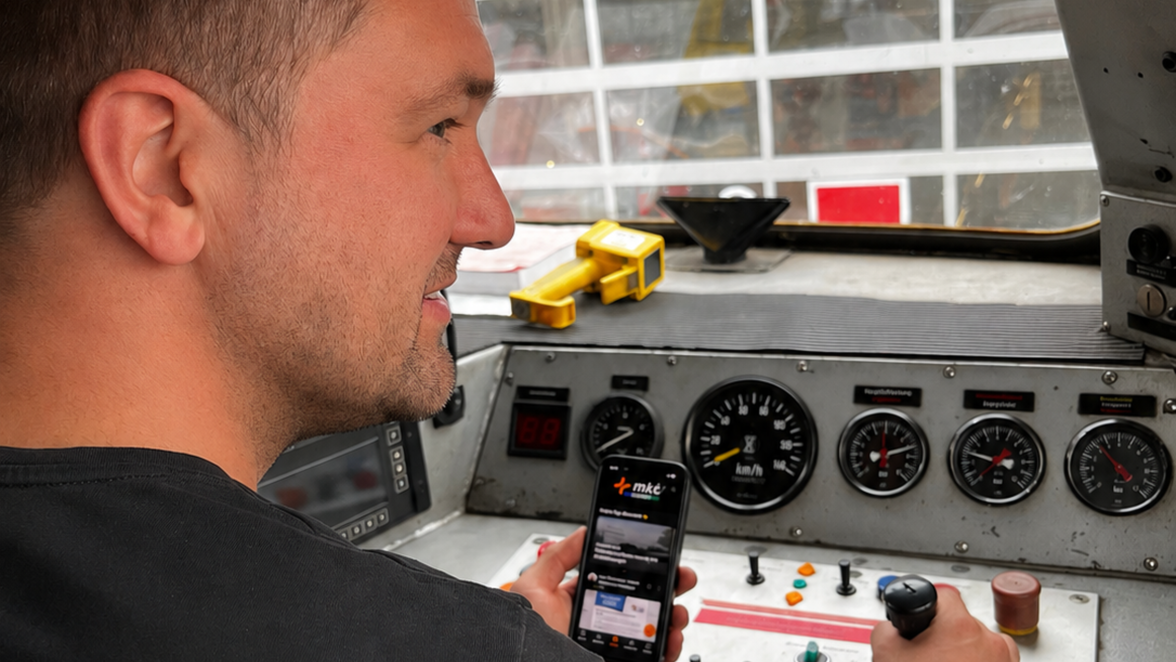 Person operating a train using a mobile app.