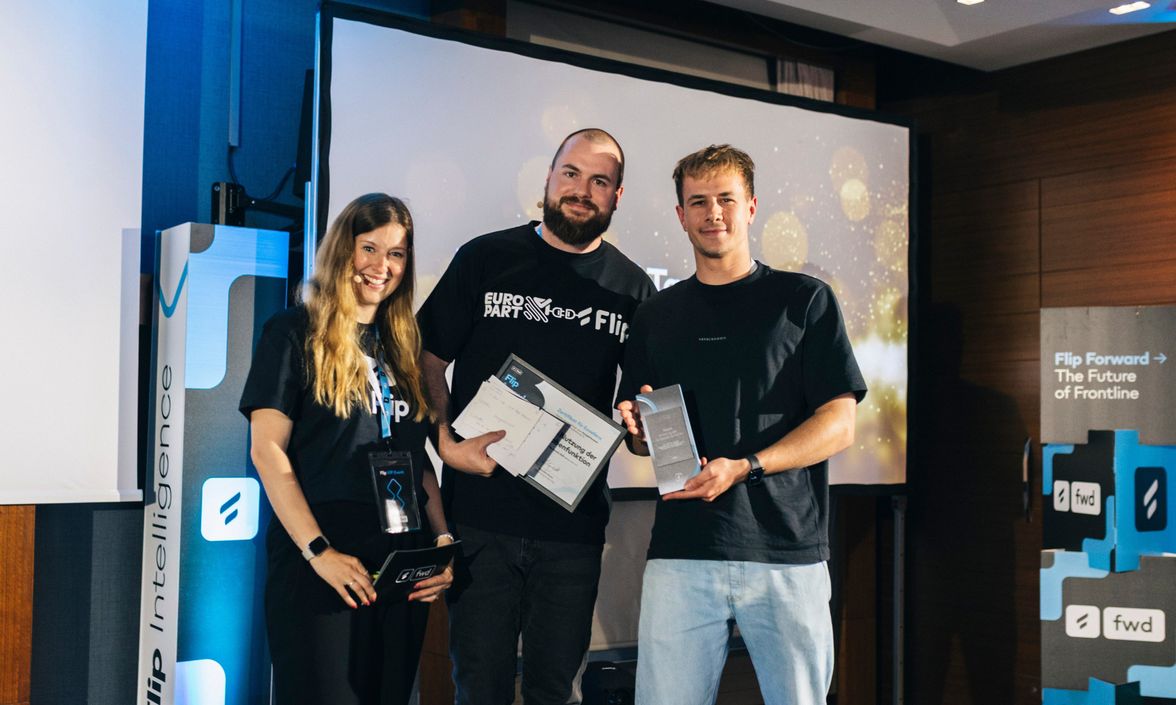 Three people holding awards at Flip Forward event; visible text: Flip Intelligence, Flip Forward → The Future of Frontline, E